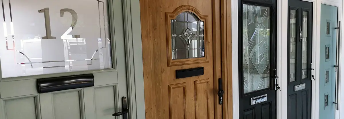 The Admiral showroom door wall: sage, golden oak, black and duck-egg front doors side by side.